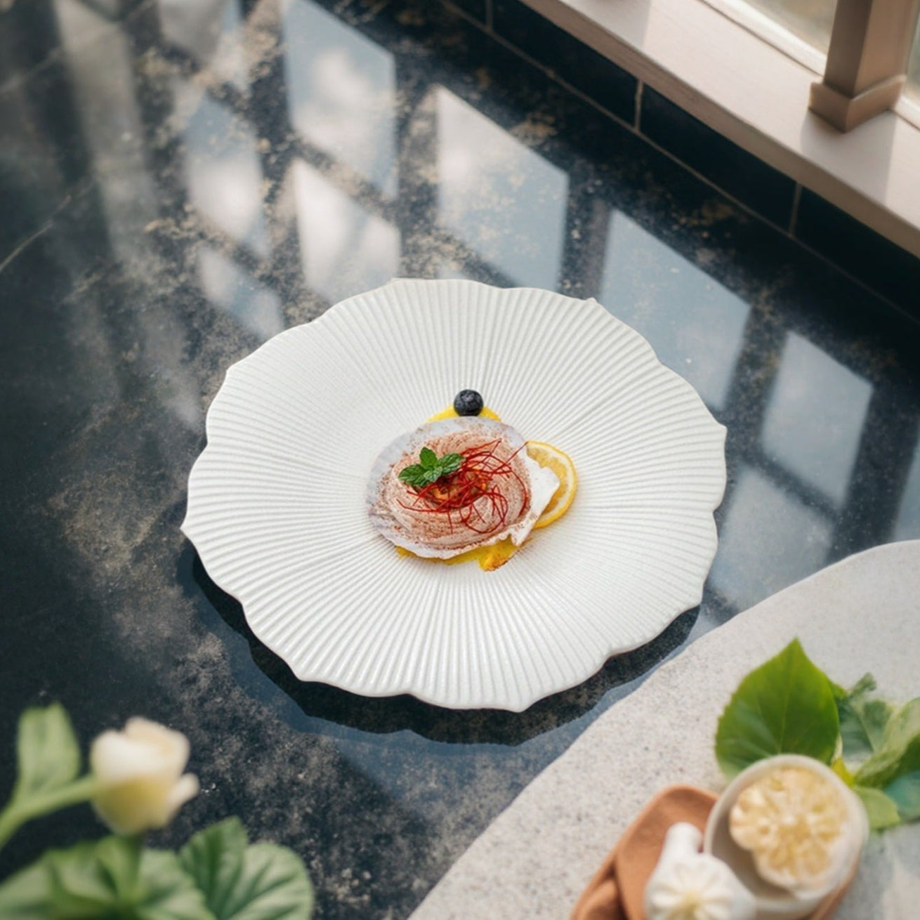 Inspired by nature’s floral beauty, this artisanal plate features a flower-shaped design with fine radial grooves and soft scalloped edges, providing an elevated visual appeal that enhances any culinary creation.