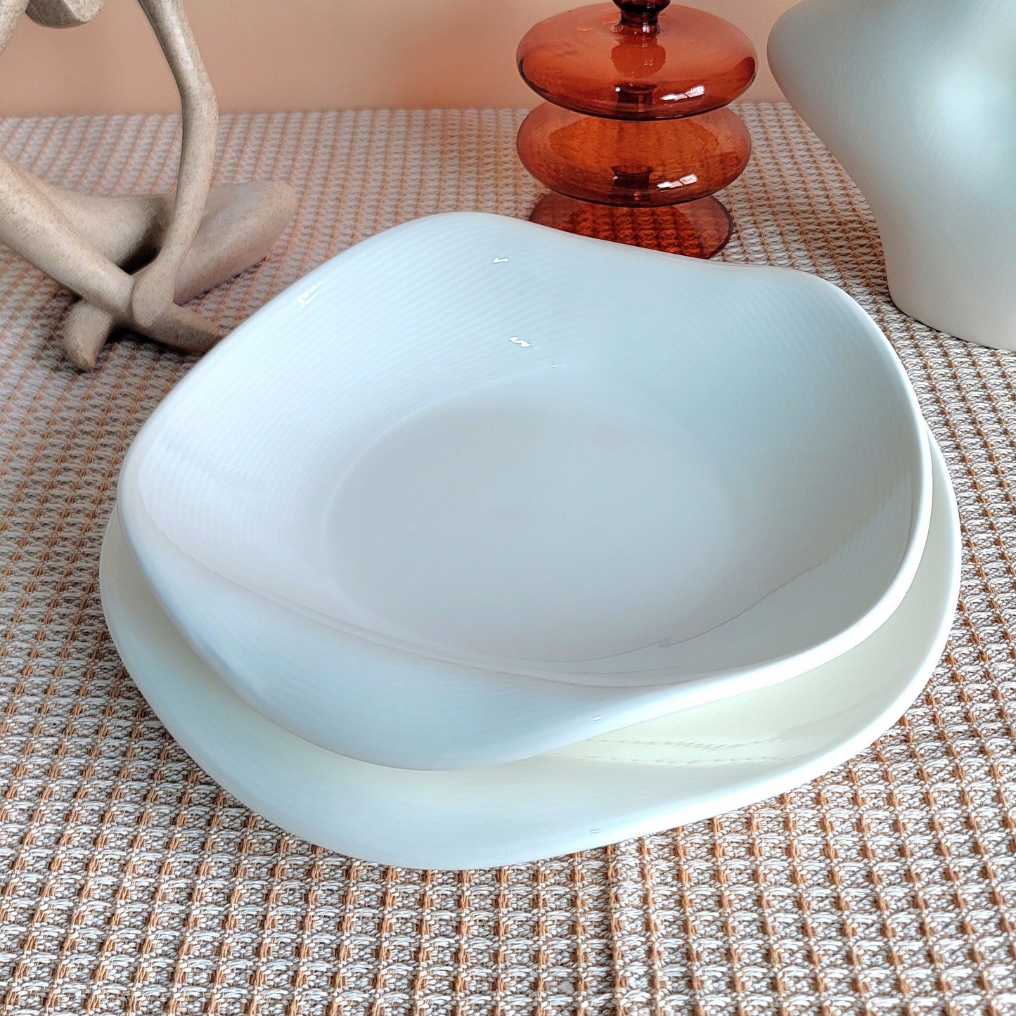 White bowl on a textured surface with a beige background