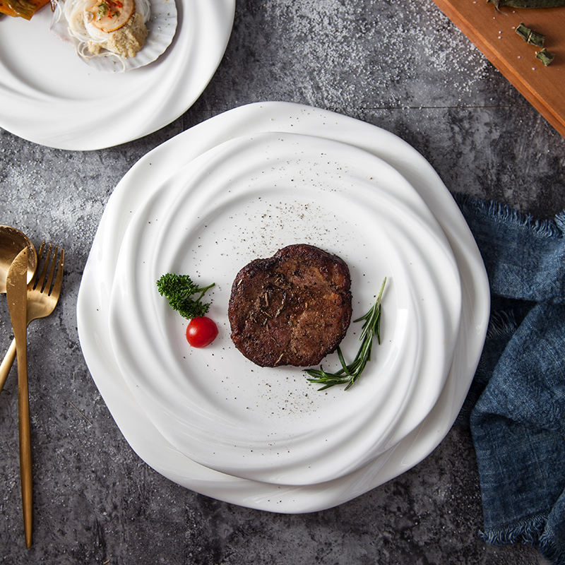 Crafted with artistic precision, the plate features a concentric wave-inspired design that creates a striking visual centerpiece.