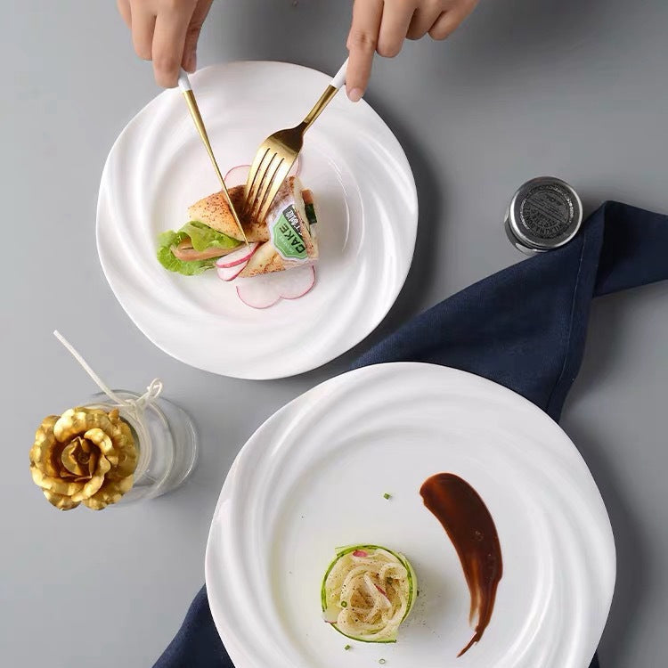 Crafted with artistic precision, the plate features a concentric wave-inspired design that creates a striking visual centerpiece.