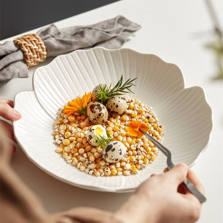 Featuring a glossy white finish and a gently scalloped edge that mimics petals, creating a soft, organic appeal.