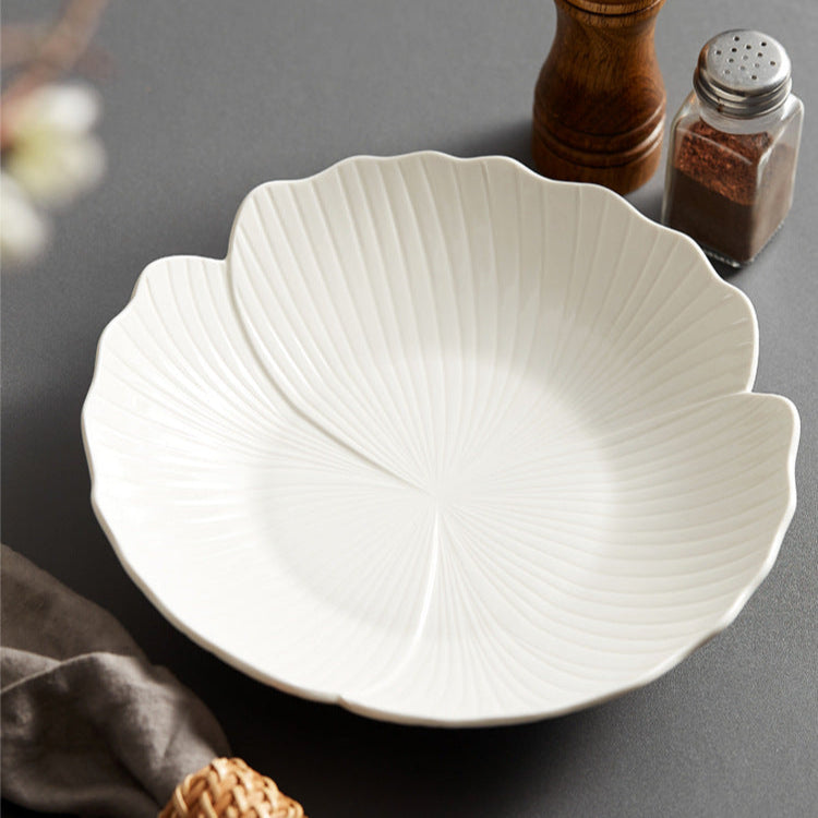 Featuring a glossy white finish and a gently scalloped edge that mimics petals, creating a soft, organic appeal.