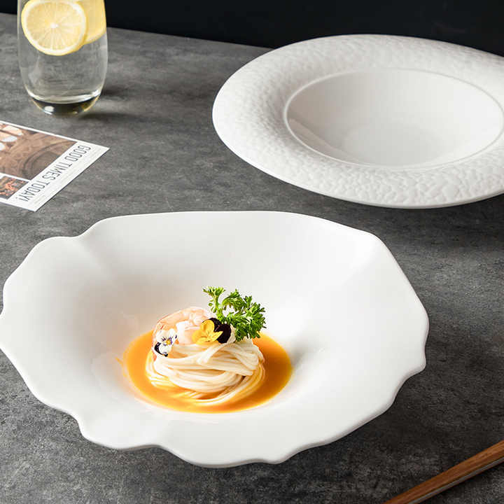 White ceramic dish with a delicate food presentation on a gray surface