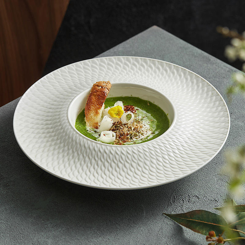 A luxury porcelain presentation plate featuring a deep well ideal for soups, purees, or gourmet plated dishes.