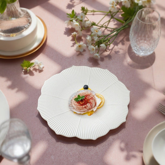 Inspired by nature’s floral beauty, this artisanal plate features a flower-shaped design with fine radial grooves and soft scalloped edges, providing an elevated visual appeal that enhances any culinary creation.
