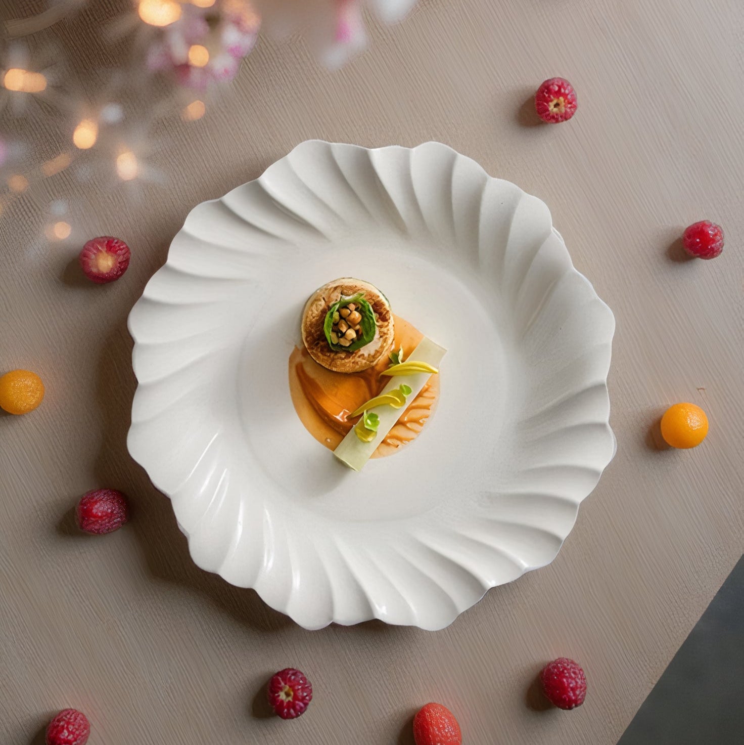Delicate dessert on a white plate with scattered fruits and flowers on a neutral background