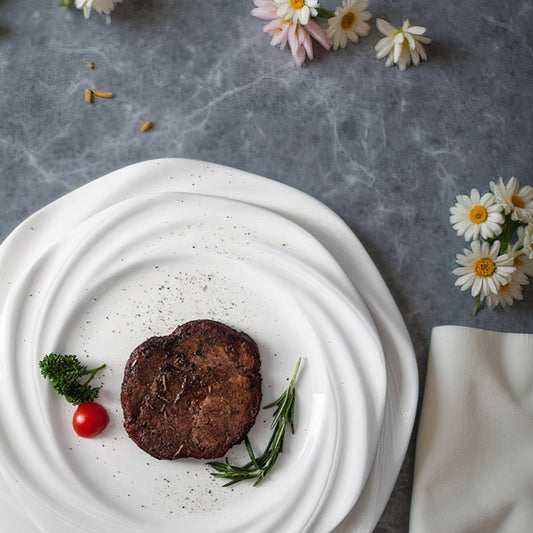 Crafted with artistic precision, the plate features a concentric wave-inspired design that creates a striking visual centerpiece.