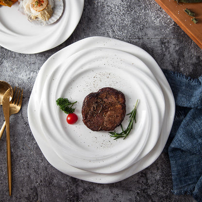 Crafted with artistic precision, the plate features a concentric wave-inspired design that creates a striking visual centerpiece.