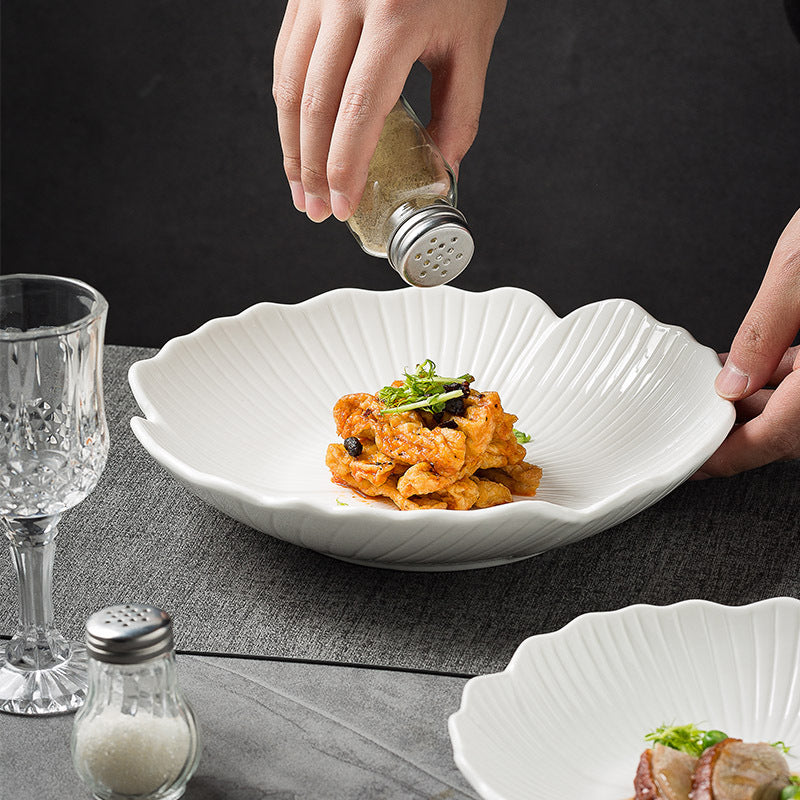 Featuring a glossy white finish and a gently scalloped edge that mimics petals, creating a soft, organic appeal.