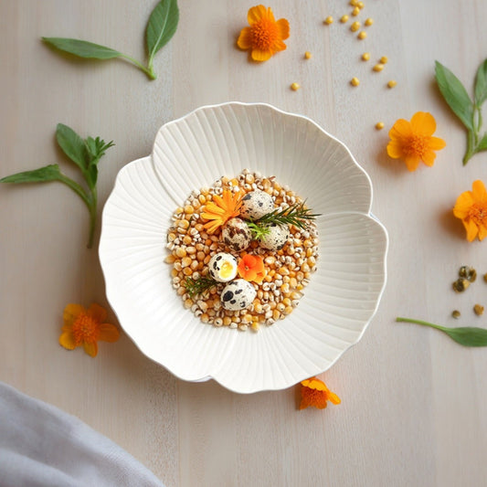 Featuring a glossy white finish and a gently scalloped edge that mimics petals, creating a soft, organic appeal.