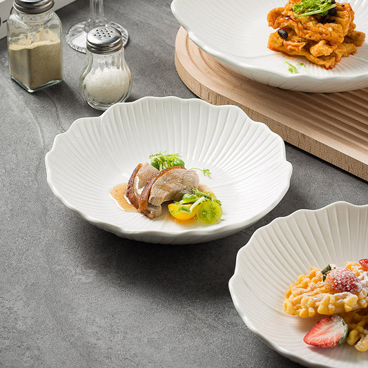 Featuring a glossy white finish and a gently scalloped edge that mimics petals, creating a soft, organic appeal.