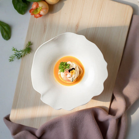 Egg dish on a white plate with garnishes on a wooden board